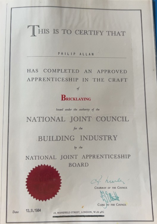 Original 1984 certificate recording that Philip Allan completed an approved apprenticeship in the craft of bricklaying, issued under the authority of the National Joint Council for the Building Industry by the National Joint Apprenticeship Board, dated 13 September 1984, with a red embossed seal
