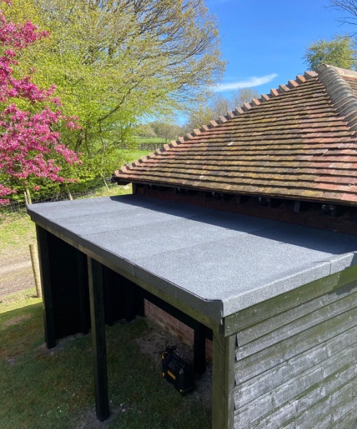New mineral felt flat roof on the outbuilding, seen from above