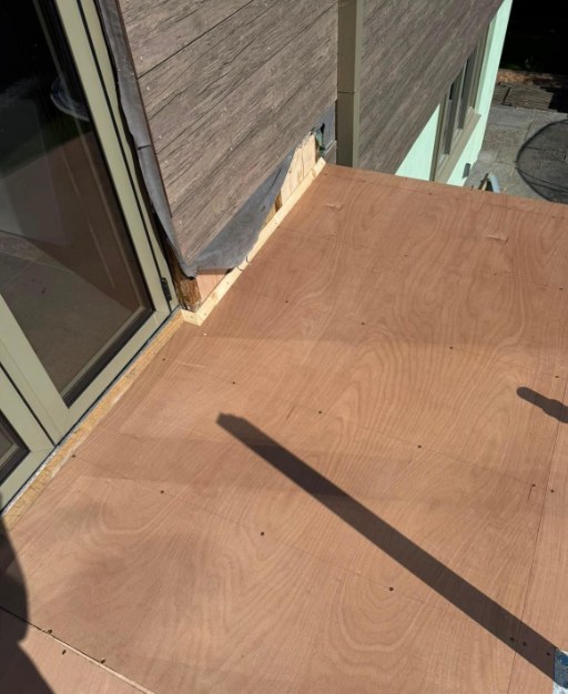 New deck boards neatly cut around the corner of the building