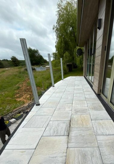 Finished tiled balcony with balustrade posts awaiting glass