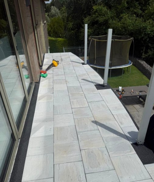 Large-format slabs being laid on the new balcony deck