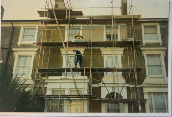 Original archive photograph: the Central Croydon town-house under scaffolding during the refurbishment works, with the front elevation and chimney stack sheeted for access