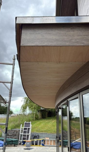 Curved soffit boards fitted beneath the balcony