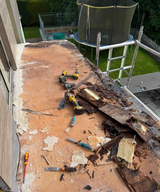 Balcony strip-out: rotten deck boards being removed