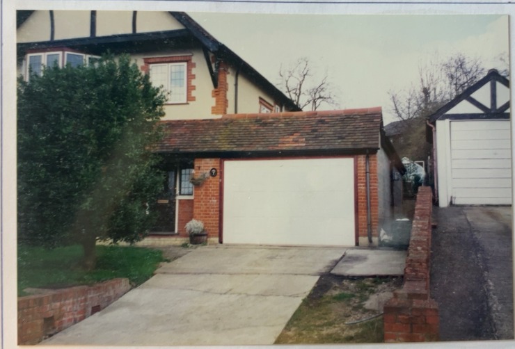 Original archive photograph: side view of the completed Coulsdon garage, porch and utility construction, showing the new brickwork and tiled roof against the original property