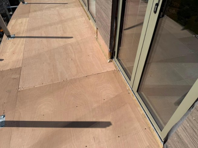 Close-up of the new deck boards fitted along the doors
